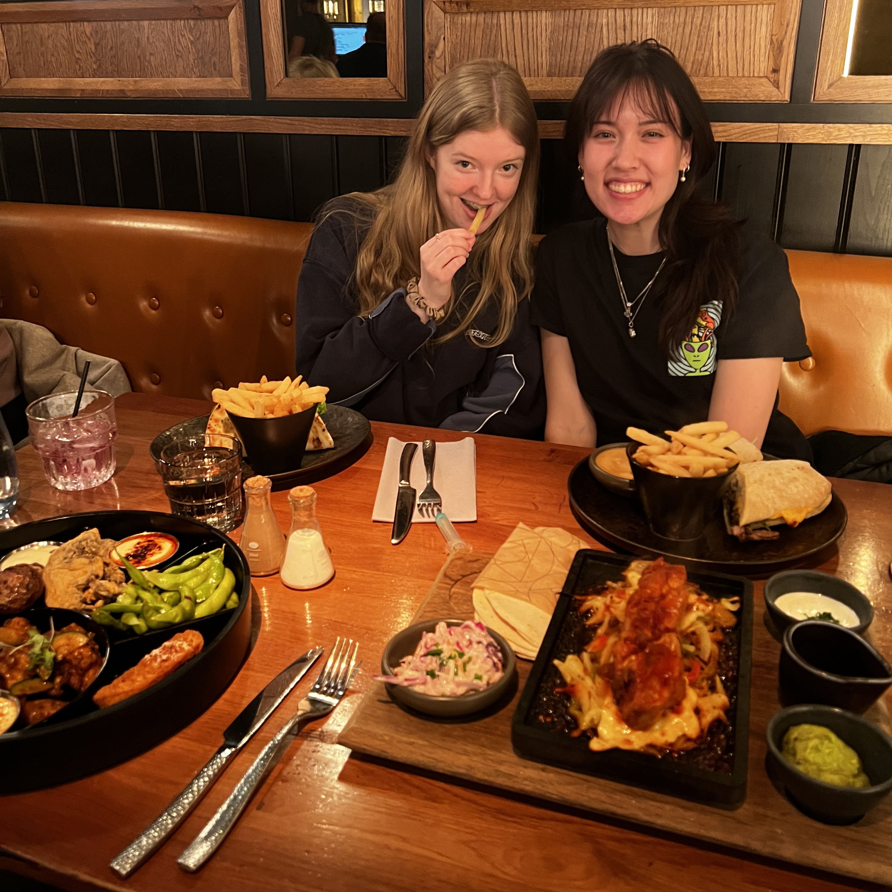 Talli and Claire sitting at a table enjoying their meal